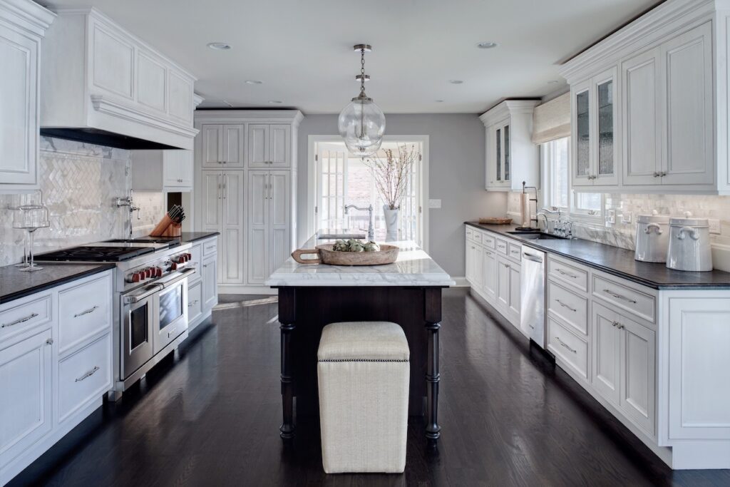 Kitchen remodeled featuring dark floors and light colored cabinets
